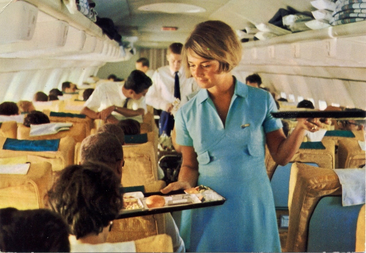 stewardess serving food in an early Boeing 707