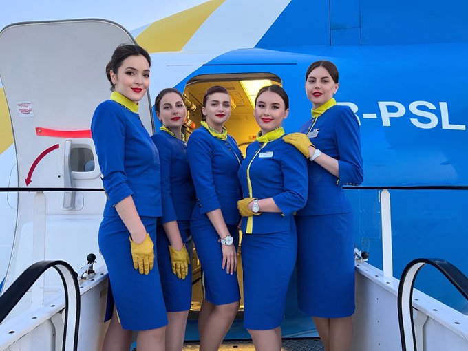 Boeing 737-900 | Ukraine international cabin crew posing at the entrance door of UR-PSL