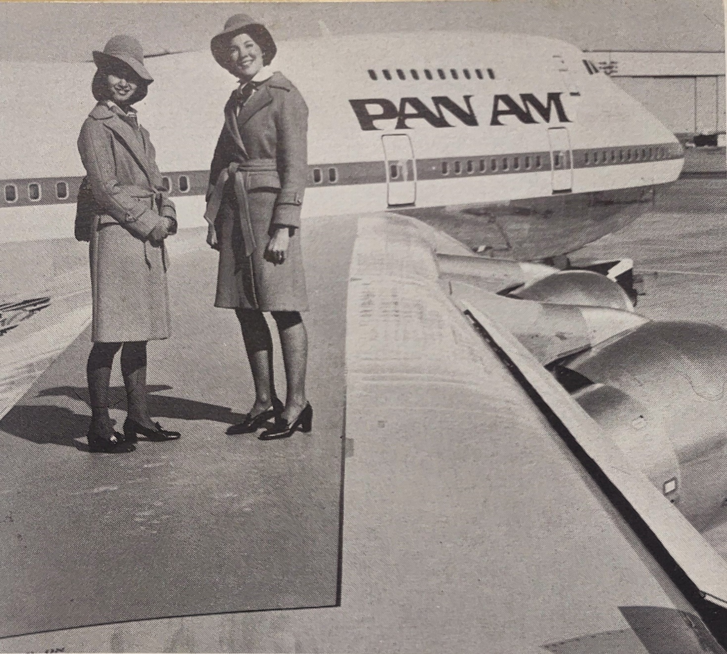 Two Pan Am stewardesses standing on the wing of a Boeing 747SP