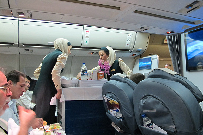 Mahan Air A300-600 Business Class Tehran to Dubai - SamChui.com cabin crew handing out food and drinks