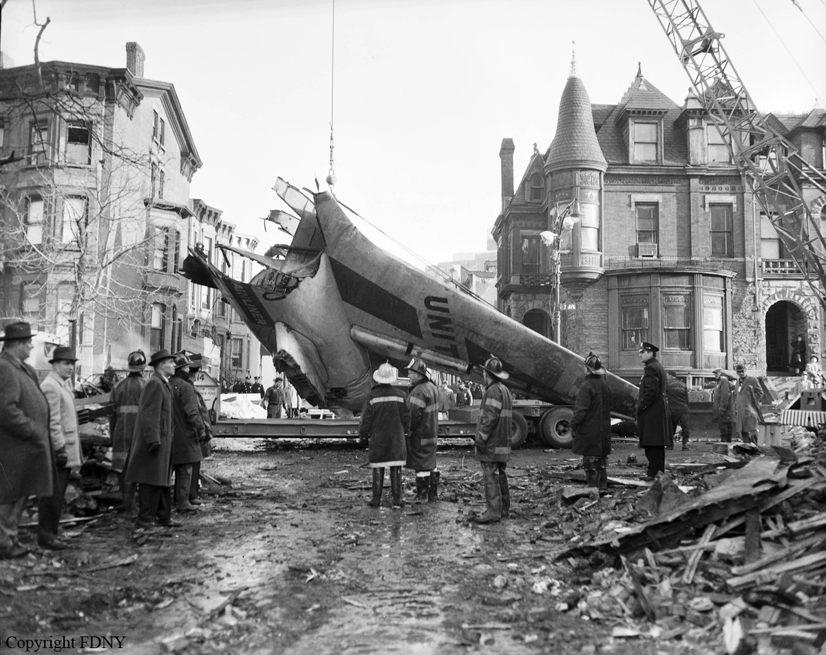 Tail of United Airlines Douglas DC-8-11 N8013U is lifted on a truck by a crane, Sterling Place, Brooklyn, December 1960