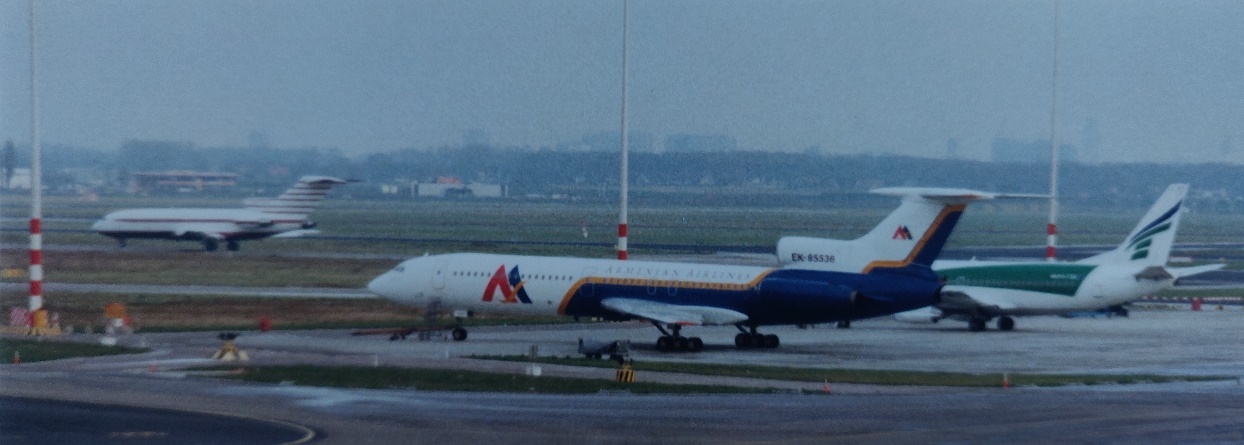 Tupolev Tu-154B2 | Armenian Airlines | EK-85536 | Tu-154B-2 parked at Schiphol with Boeing 727 taking off in the back ground.
