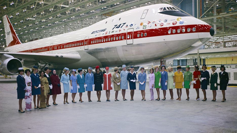 A Tribute To The Queen Of The Skies, The Iconic Boeing 747 | 747 prototype in its hangar with a line up of stewardesses