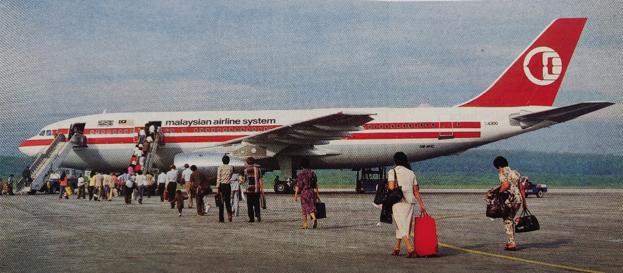 Airbus A300B4-203 | Malaysian Airline System | 9M-MHC | passengers boarding an A300B4 wide-body jetliner