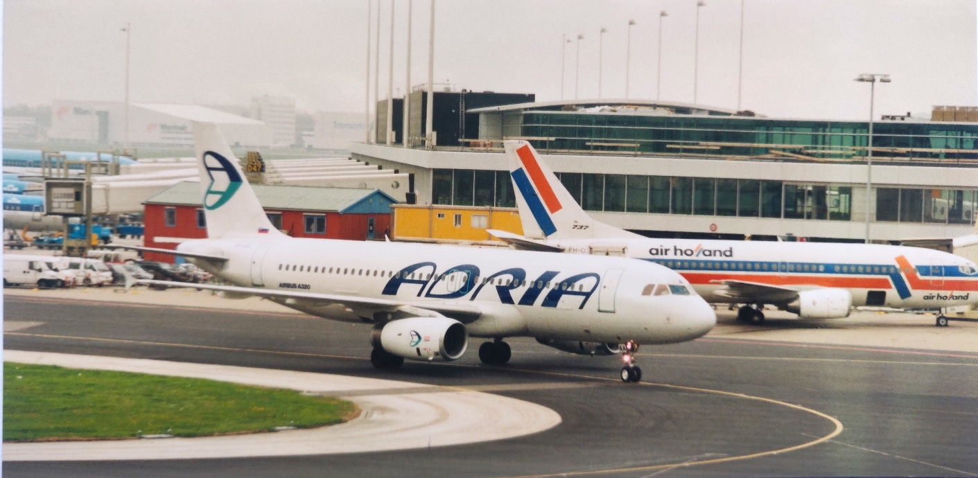 Airbus A320-231 | Adria airlines | A320 taxiing to the gate st Schiphol airport with Air Holland 737 in the background.