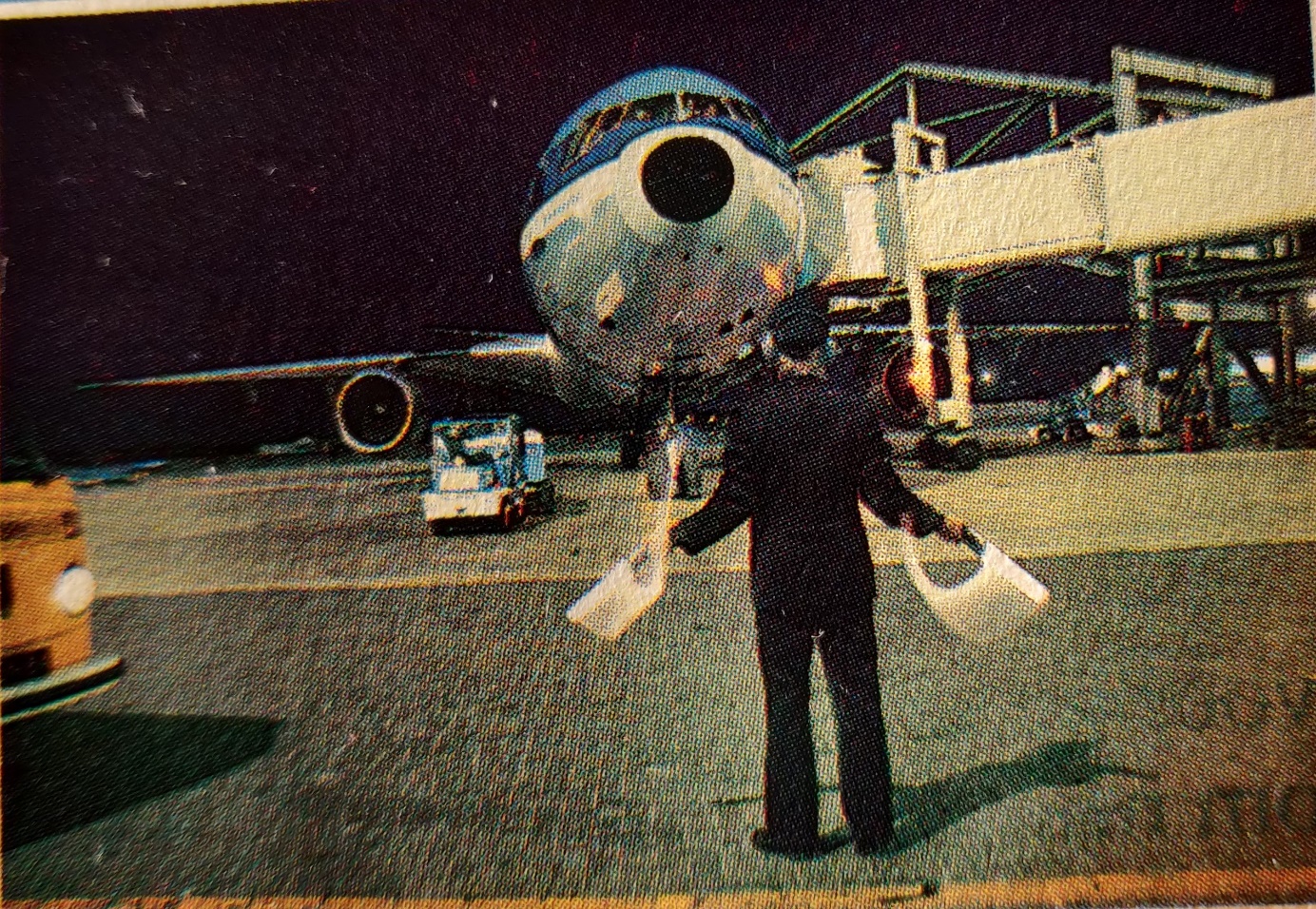 McDonnel Douglas DC-10-30 at the gate with marshall giving directions to the pilot with Volkswagen T2 van in the left corner