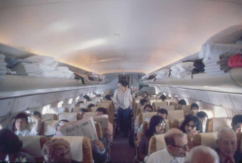 Japan Air Lines DC-8 interior with passengers and blankets