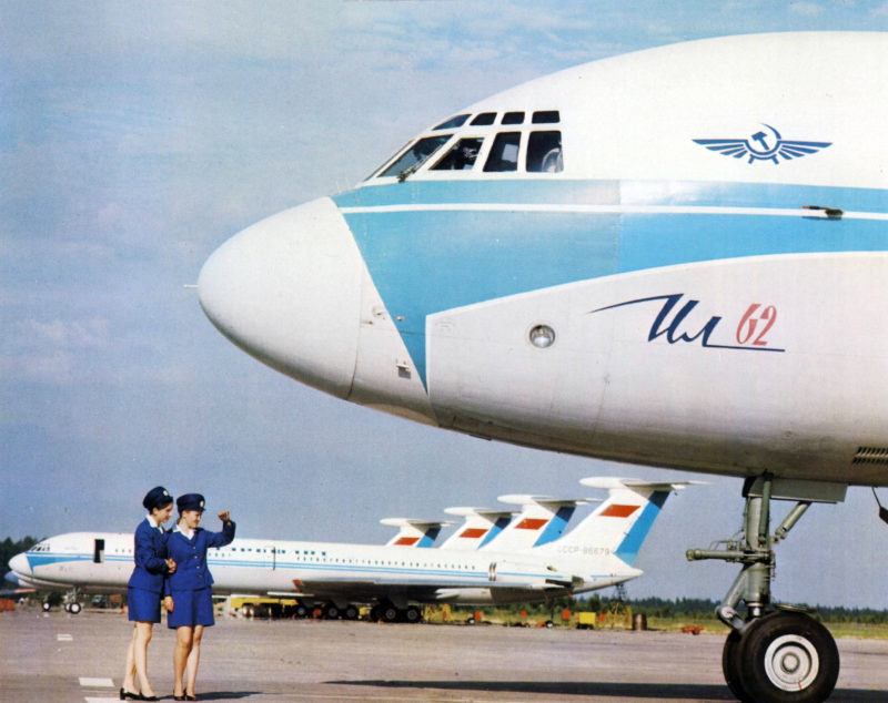 Line up off Ilyushin Il-62 jetliners | CCCP-86679 | two stewardesses looking to something