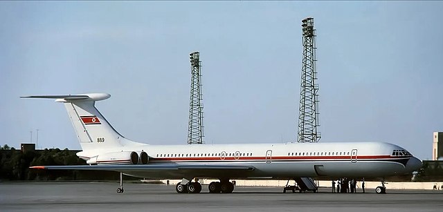 Ilyushin Il-62M | CAAK } P-889 | parked on the ramp with people standing beside the aircraft