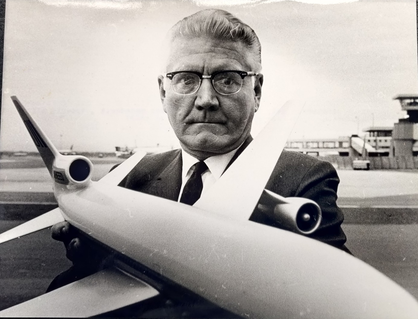 Lockheed president A.C. Kotchian holding a Lockheed L1011 model in his arms