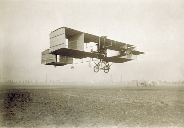 Delagrange's Voisin biplane in flight" by J. Theodoresco