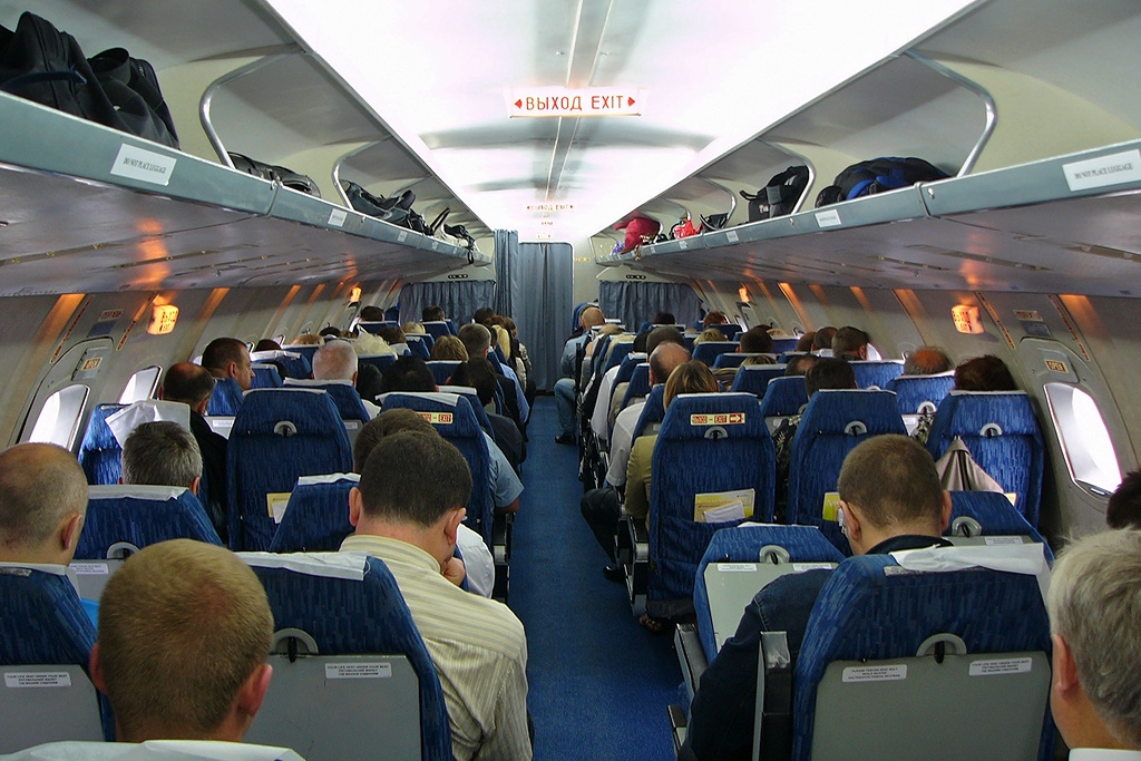 A group of people sitting in a plane

Description automatically generated with low confidence