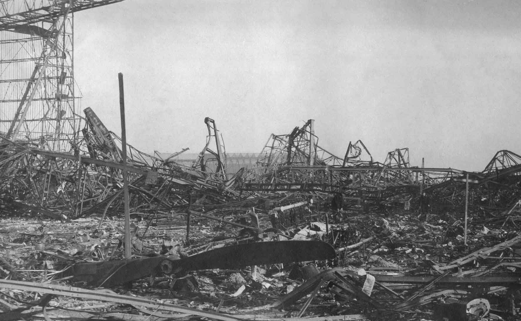 burned remains of a Zeppelin and its hangar, what is left of it, with a Zeppelin propellor in front