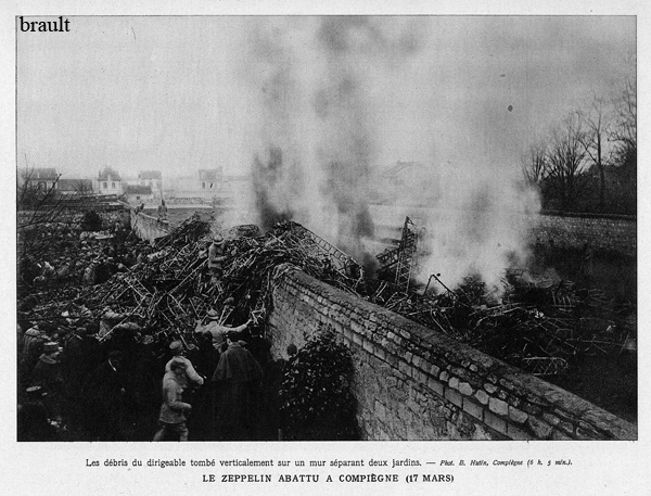 France soldiers inspecting the smoldering wrackage of Zeppelin LZ86 L39 which crashed on a wall in a garden in Compiegne near Boulevard Gambetta